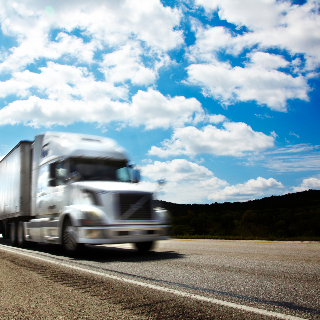 White food logistics truck driving